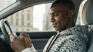 GEICO insurance quote online — driver comparing car insurance rates on mobile app in 2026